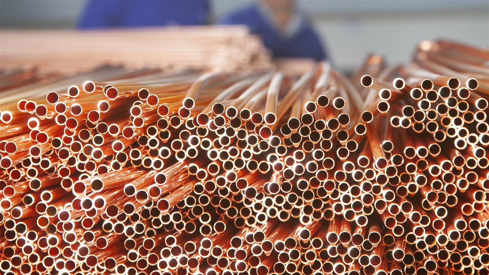 A large stack of freshly cut pipes