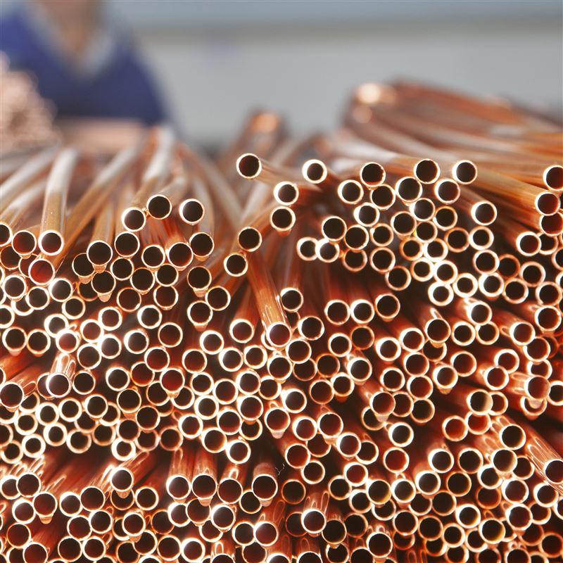 A large stack of freshly cut pipes