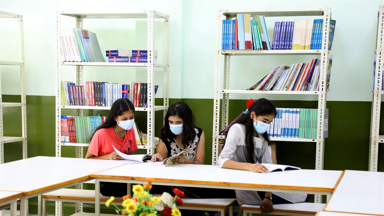 Students at the Adarsha Secondary School in Bhaktapur enjoy reading new books.