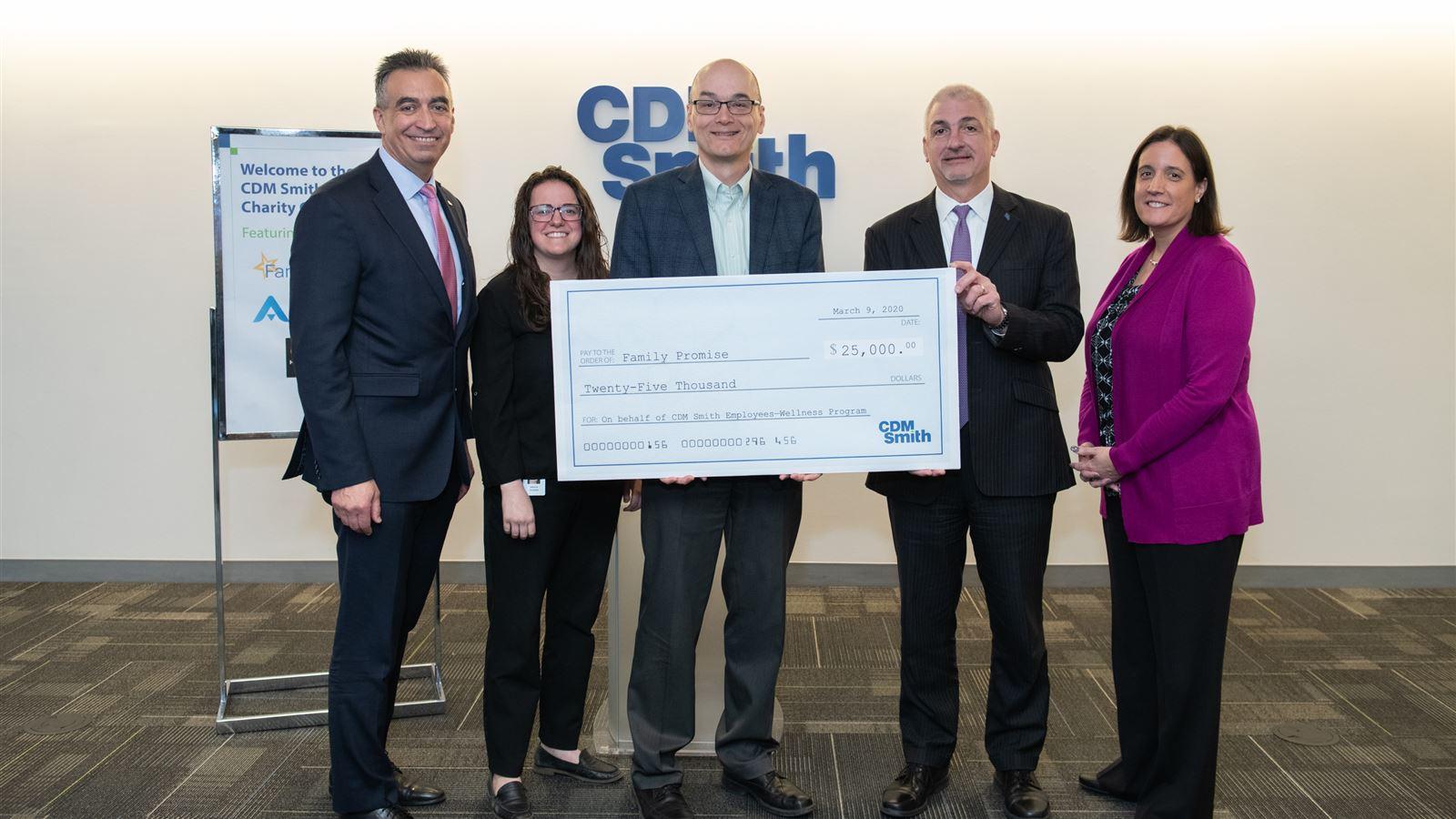 CDM Smith presents a $25,000 check to Claas Ehlers, Chief Executive Officer of Family Promise.