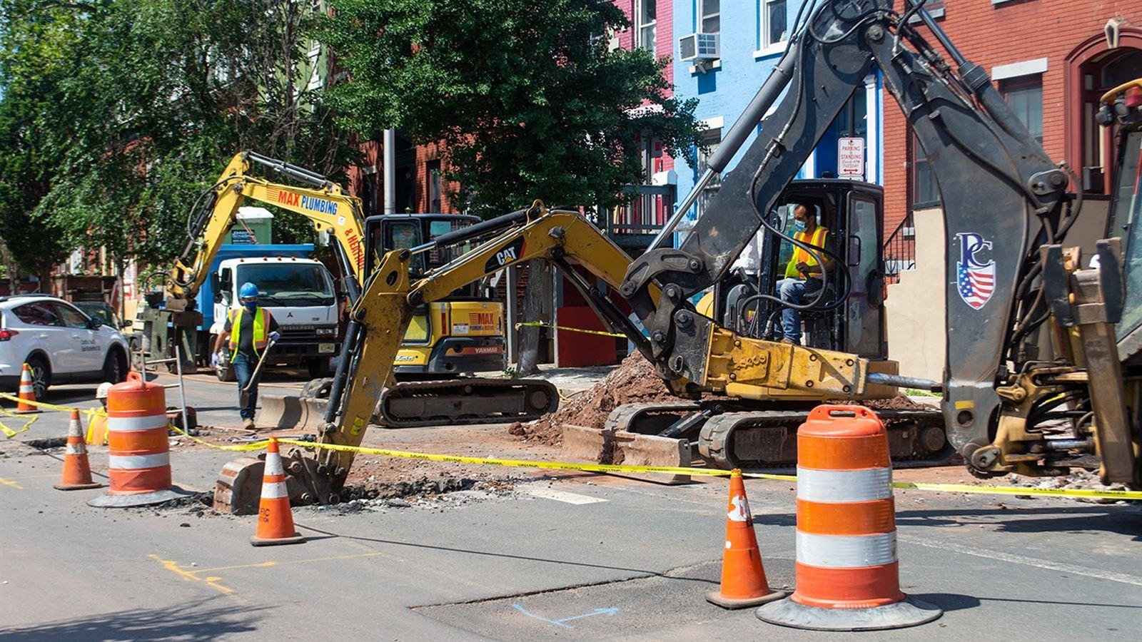 An excavator digs up a street in Newark, NJ as part of the city's lead service line replacement program