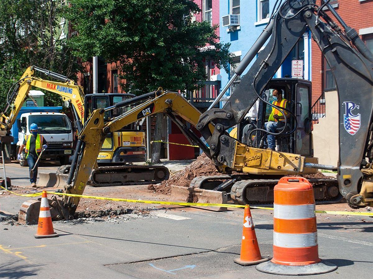 An excavator digs up a street in Newark, NJ as part of the city's lead service line replacement program