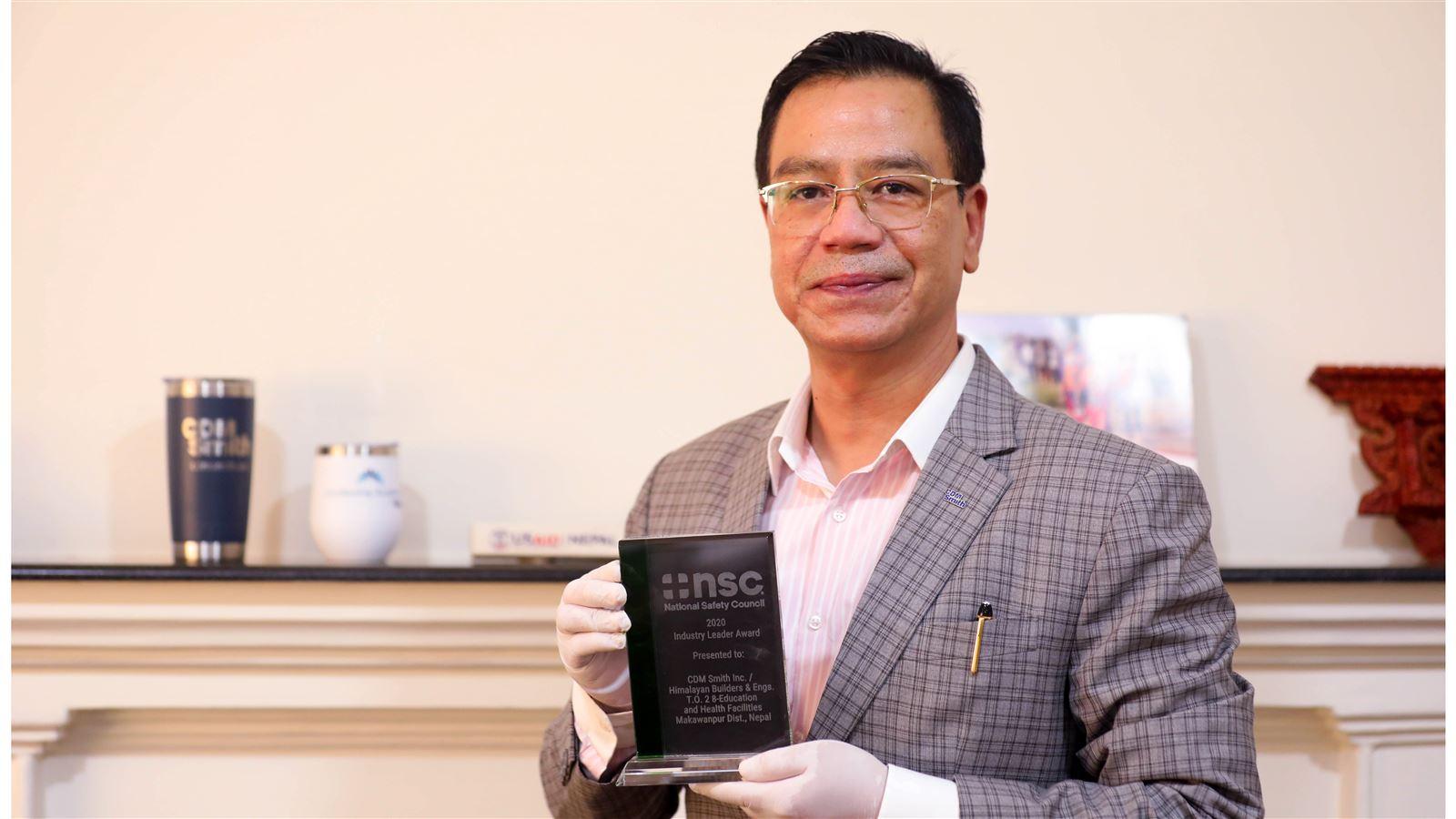 USAID’s NRES Chief of Party Rajeev Thapa holds the National Safety Council&#39;s 2020 Industry Leader Award.