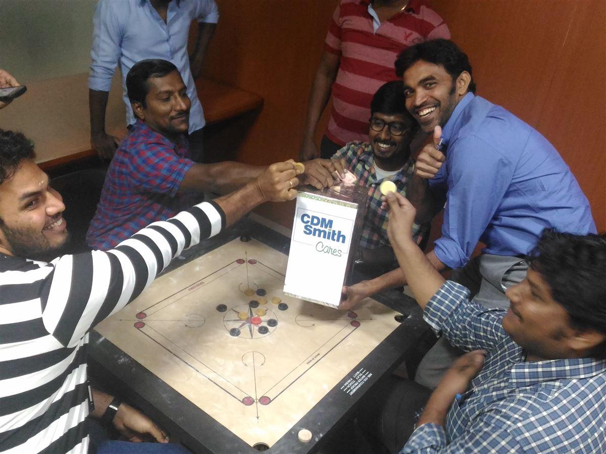 6 people around a table hosting a fundraiser to support Water for People