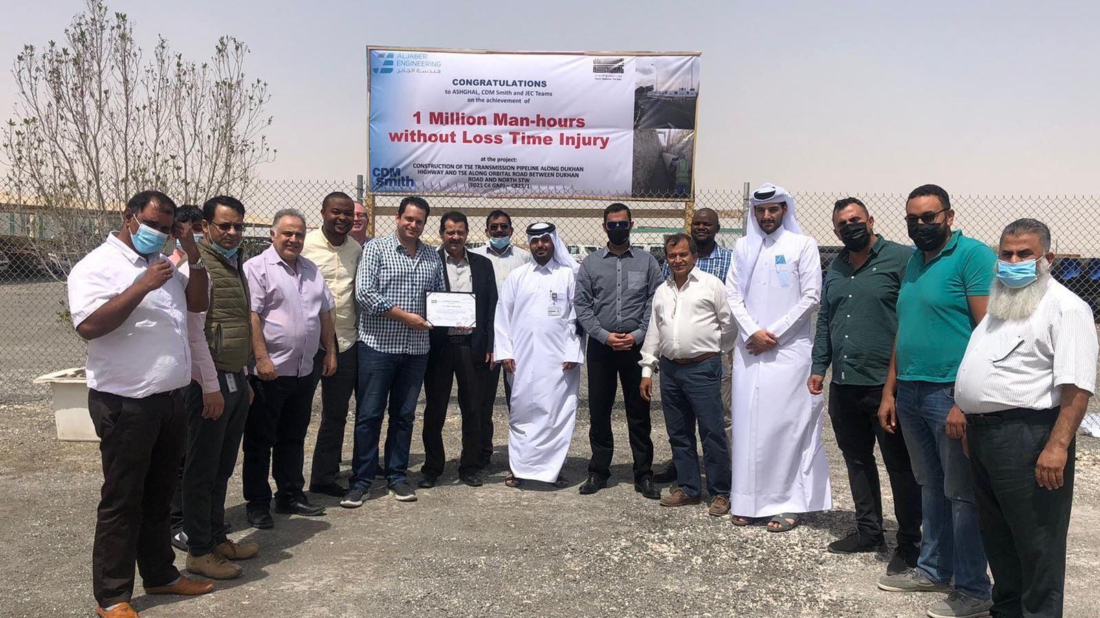 group of men with safety award sign