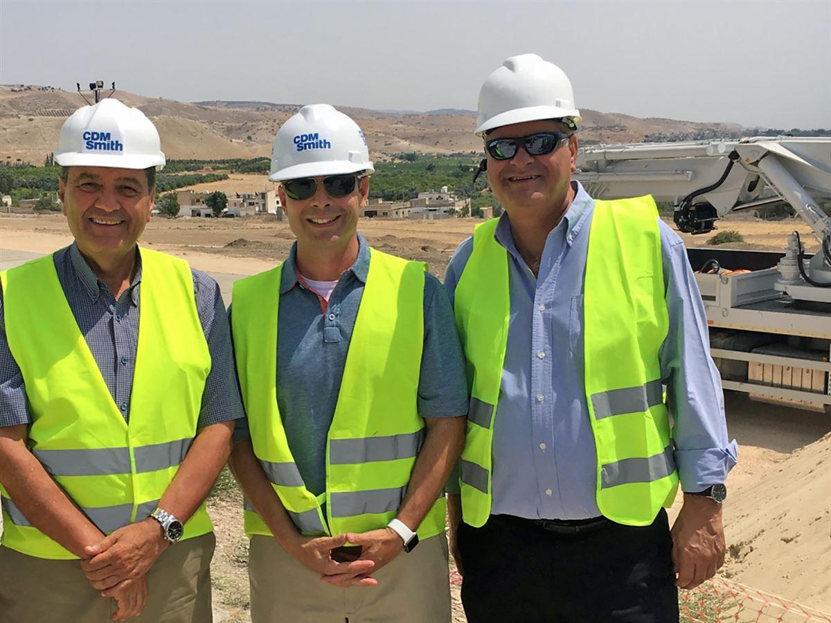 3 CDM Smith employees with hardhats smiling
