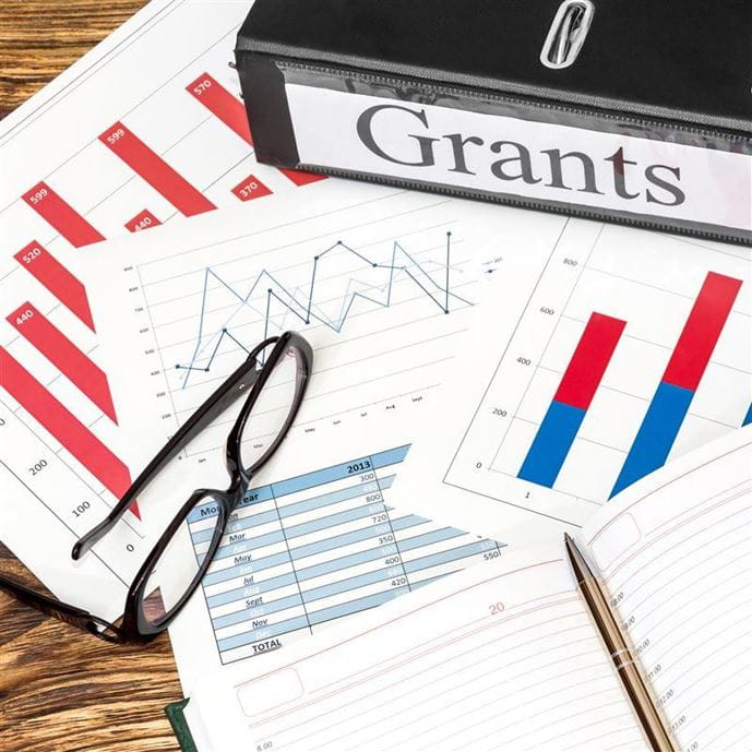 Hero image of papers spread around for a grant application