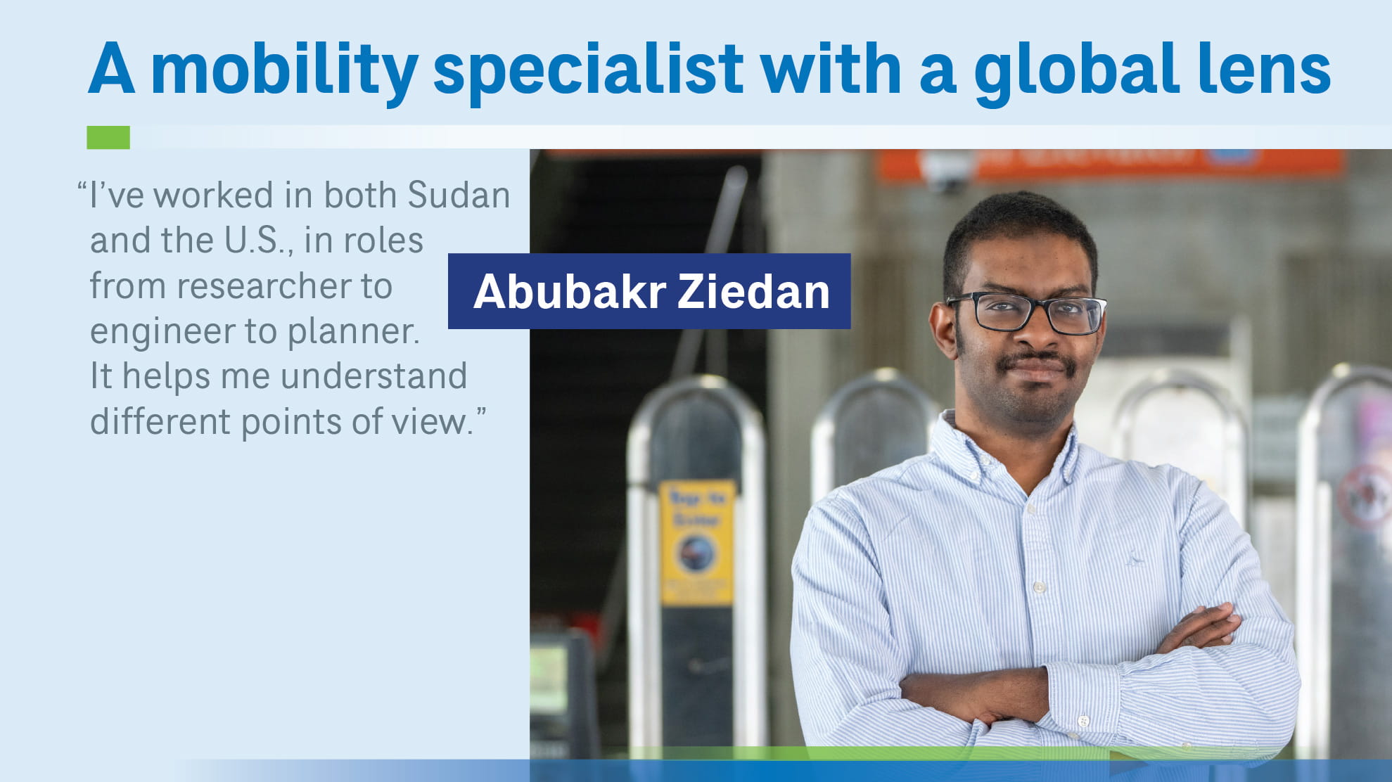 man with arms folded at a train station