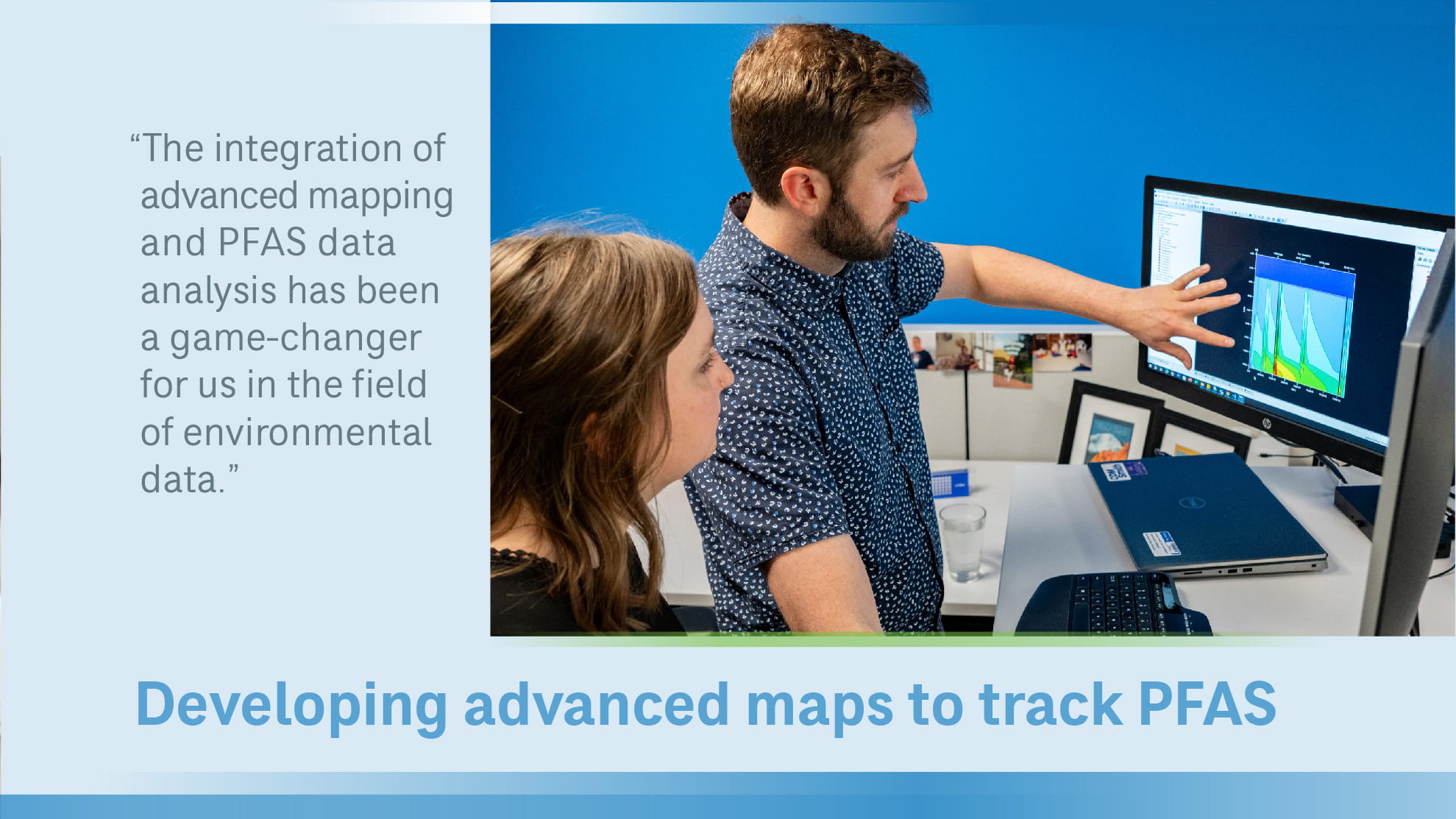 John Stults standing at computer with woman