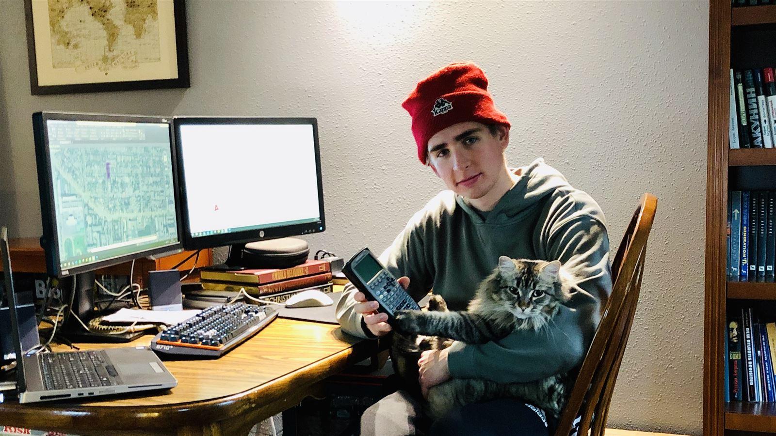 Daneel Ruppert works from home with his cat,