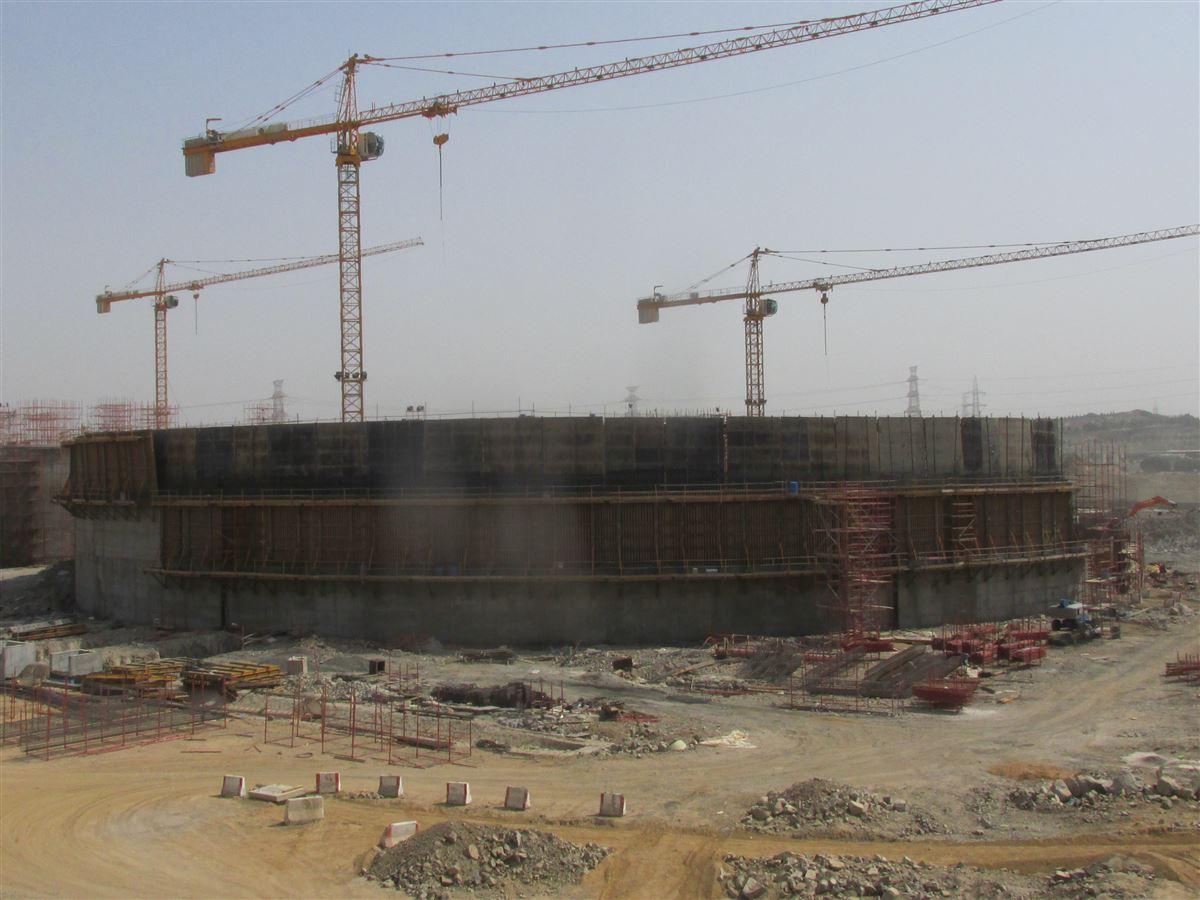 Birman strategic water reservoir with three large cranes in the background